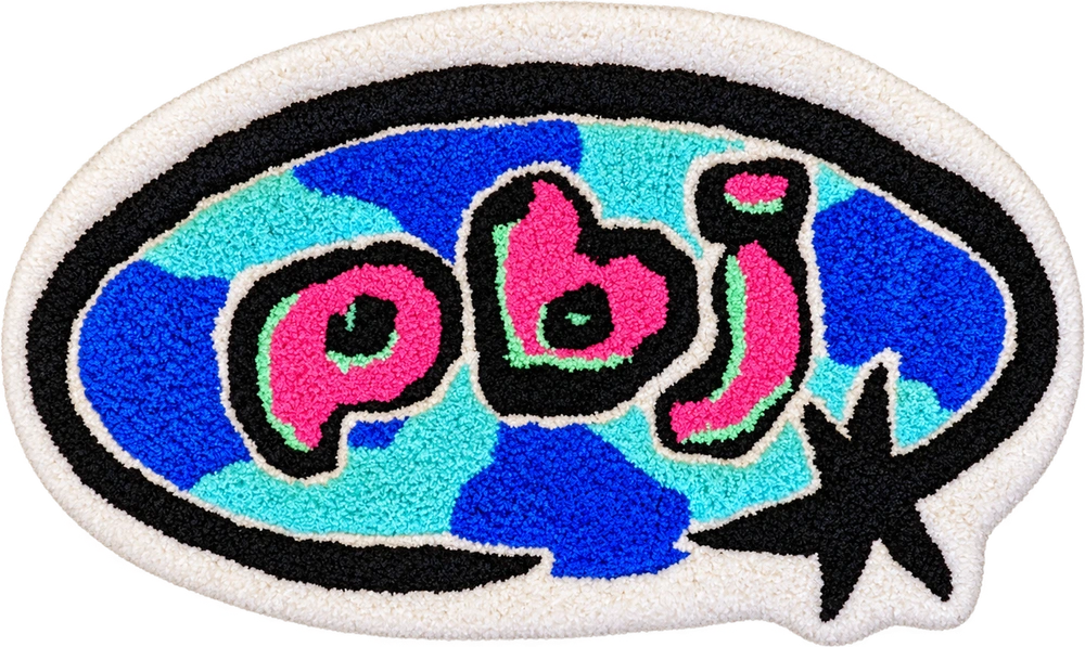 Tufted PBJ Effects rug with pink lettering, blue and cyan panels, and a black oval and star